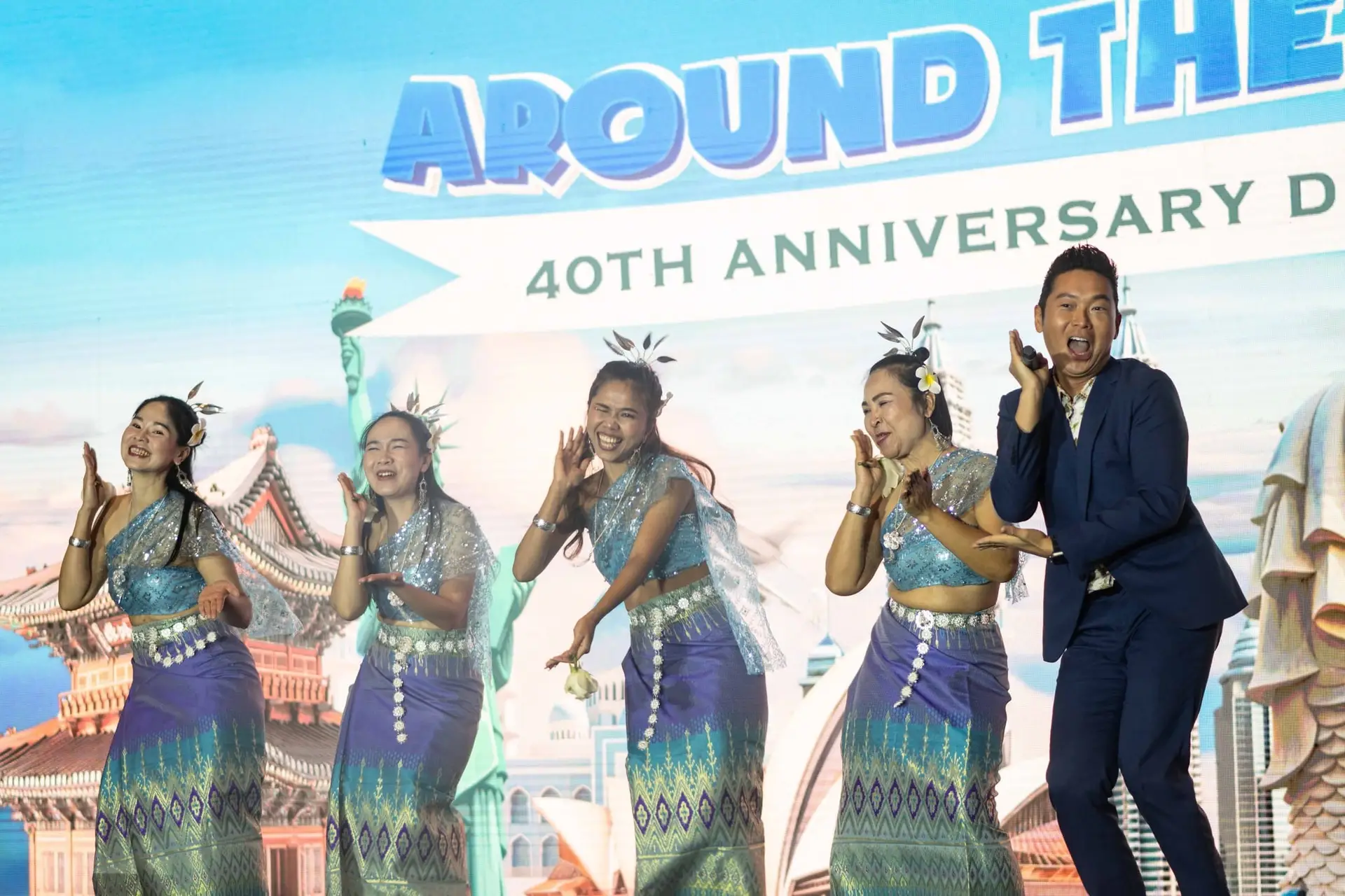 James Yang dancing with performers at a 40th anniversary event